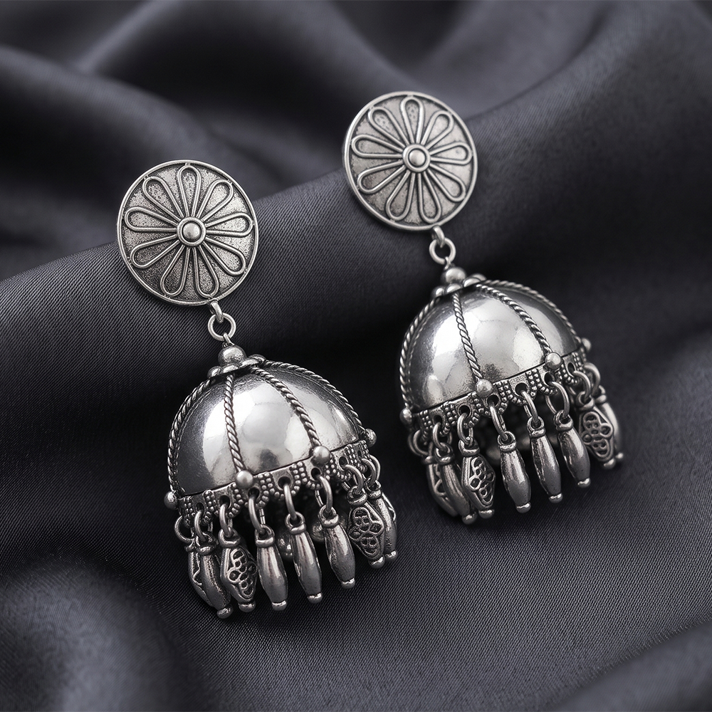 The99Jewel These oxidised silver jhumka earrings feature a floral stud for Women