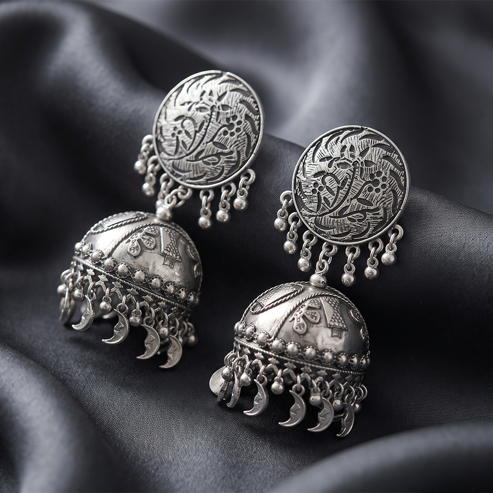 The99Jewel These oxidised silver jhumka earrings feature a floral stud for Women